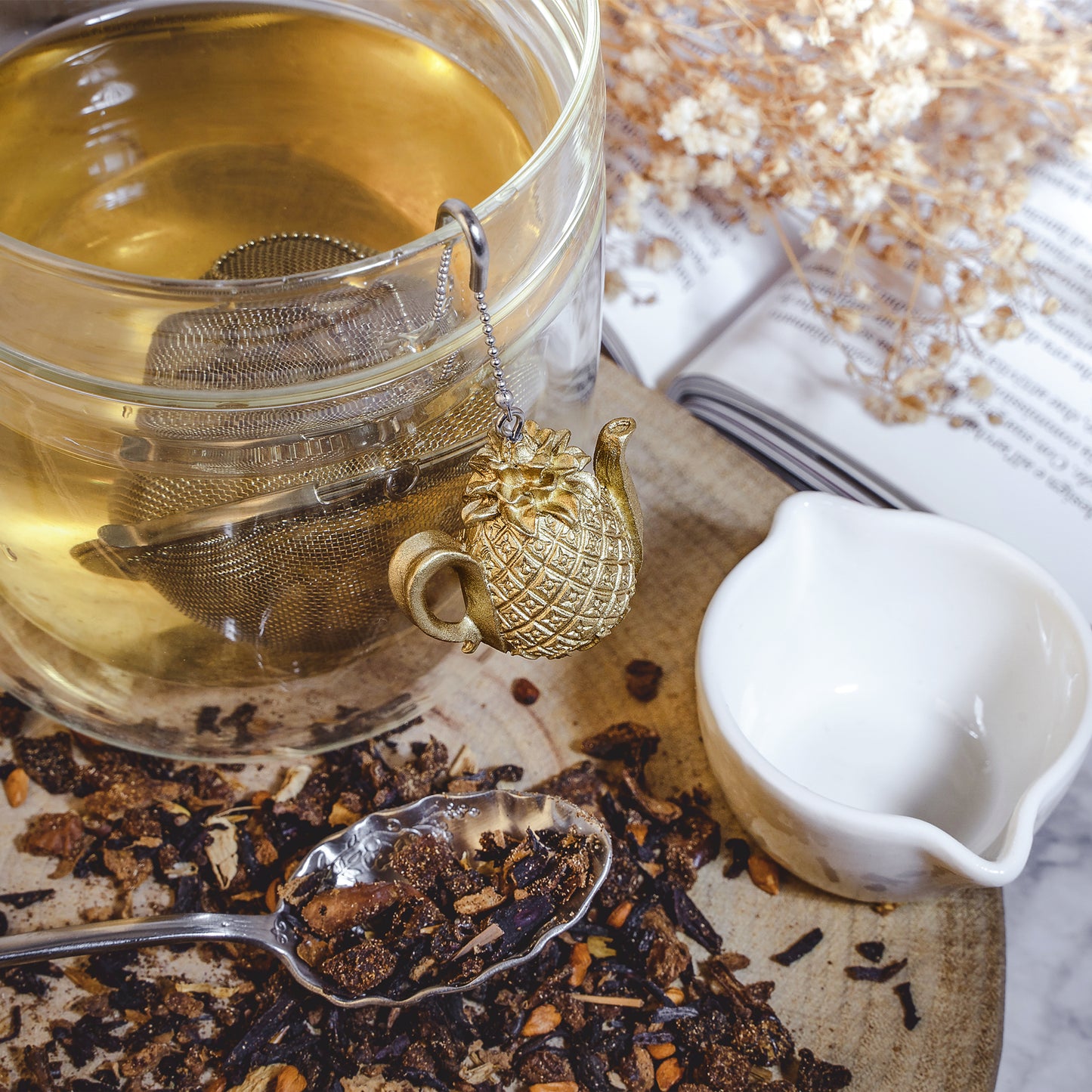 Stainless steel Loose Leaf Tea Ball Infuser filled with loose-leaf tea and suspended in a cup, allowing tea leaves to steep while keeping sediment contained.