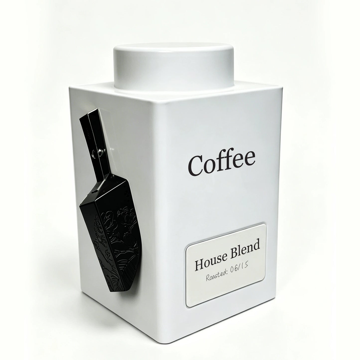 A white square coffee tin with a matching lid, featuring a black scoop attached to the side and a label that reads 'House Blend' on a clean white background.