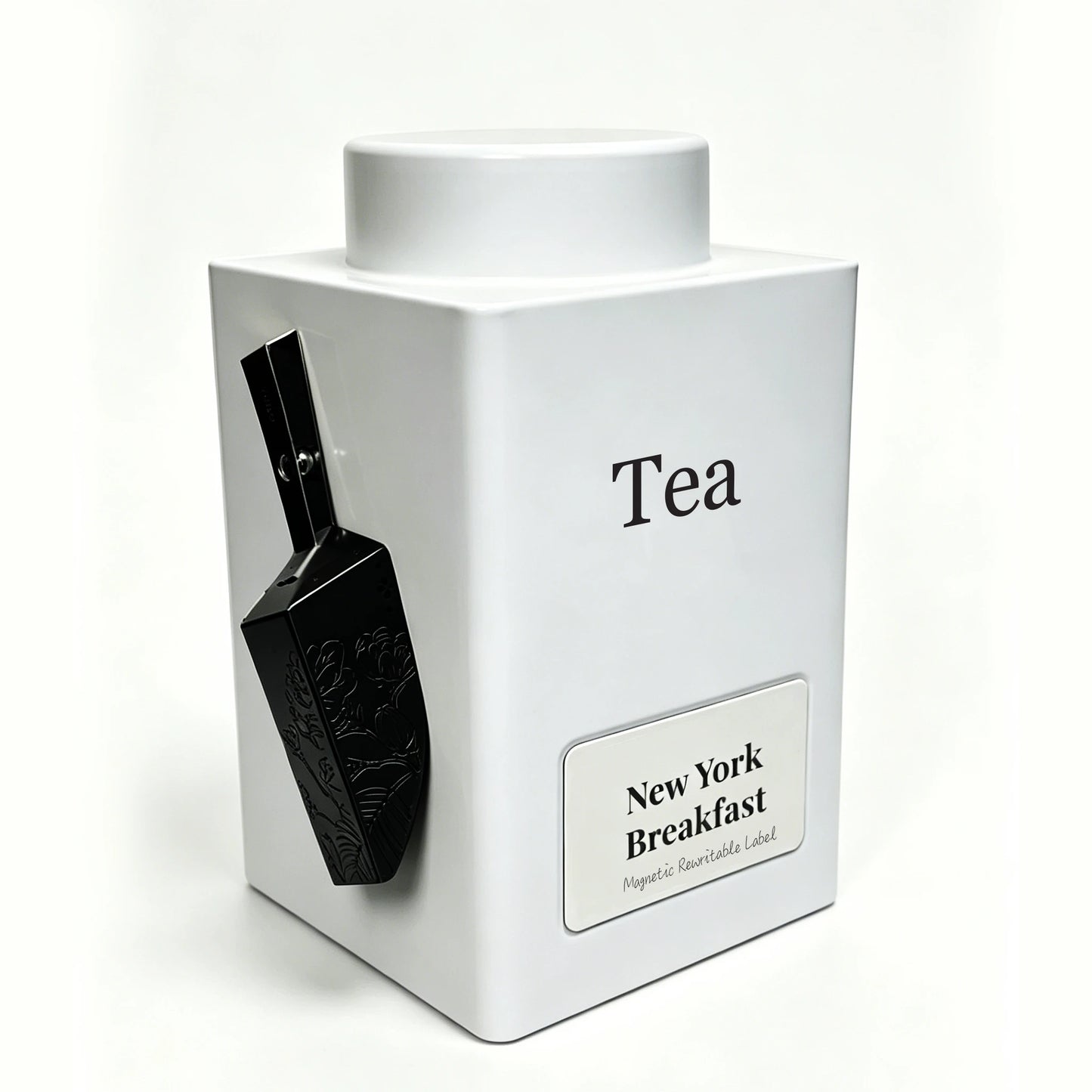 A white square tea tin with a matching lid, featuring a black scoop attached to the side and a label that reads 'New York Breakfast' on a clean white background.