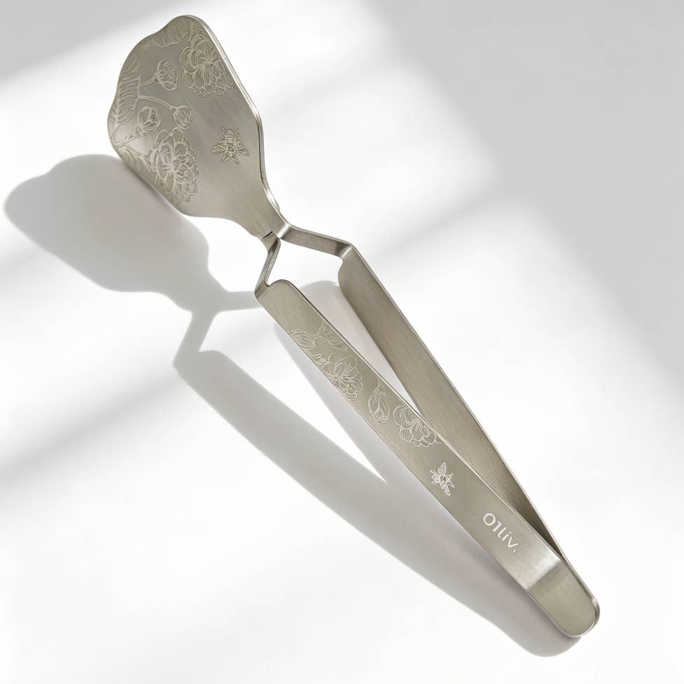 TenderPress™ Gentle Tea Bag Squeezer lifestyle image in polished silver stainless steel, designed to gently squeeze tea bags.