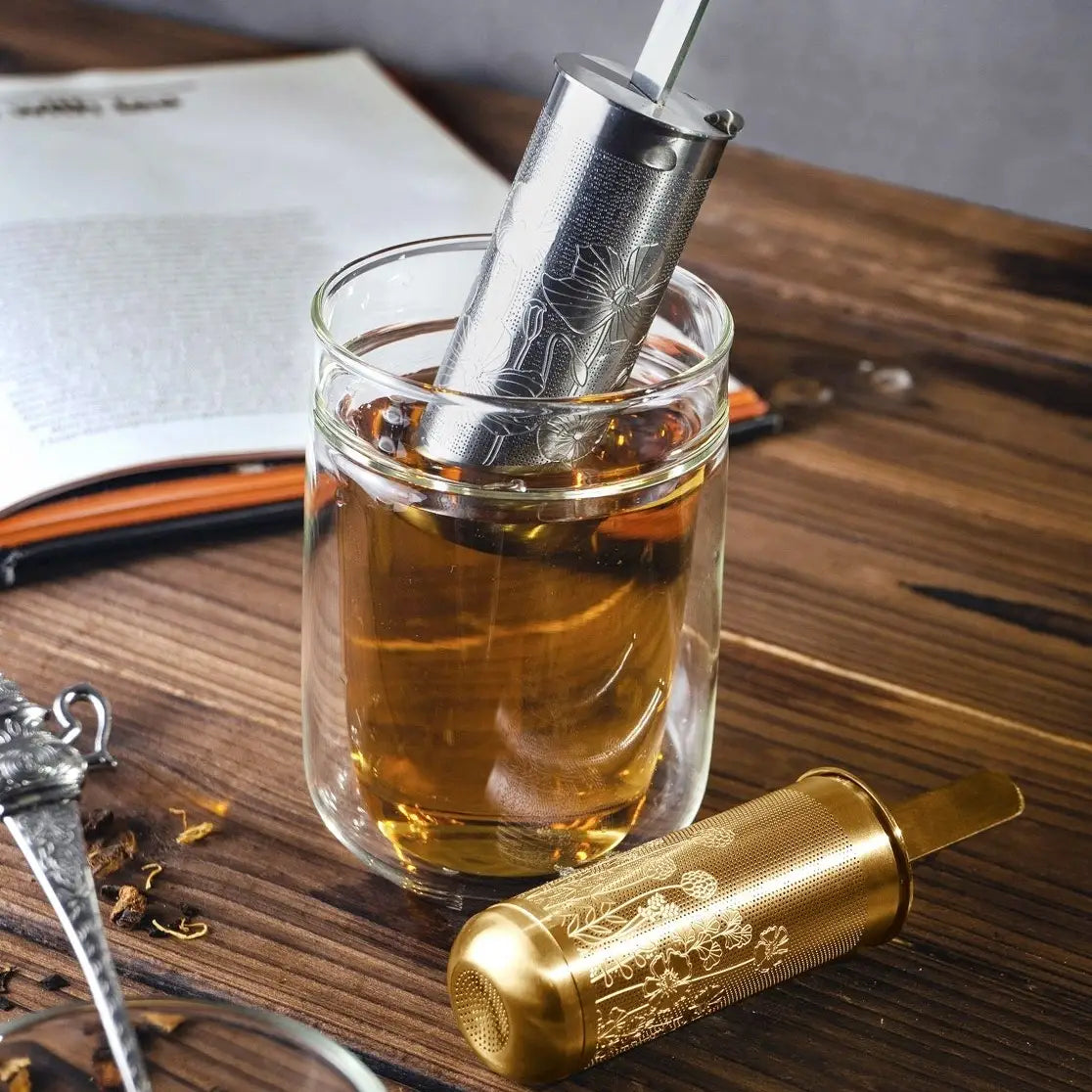 Tea Stick™ Loose Leaf Tea Infuser presented in gold and silver, showcasing the sleek dual-purpose tea scoop and infuser design.