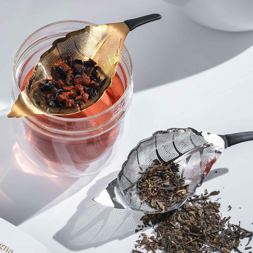 Silver & Gold Yezi™ Leaf Tea Strainer in leaf-shaped modern design, made from 304 stainless steel for filtering loose-leaf tea and sediment while pouring.